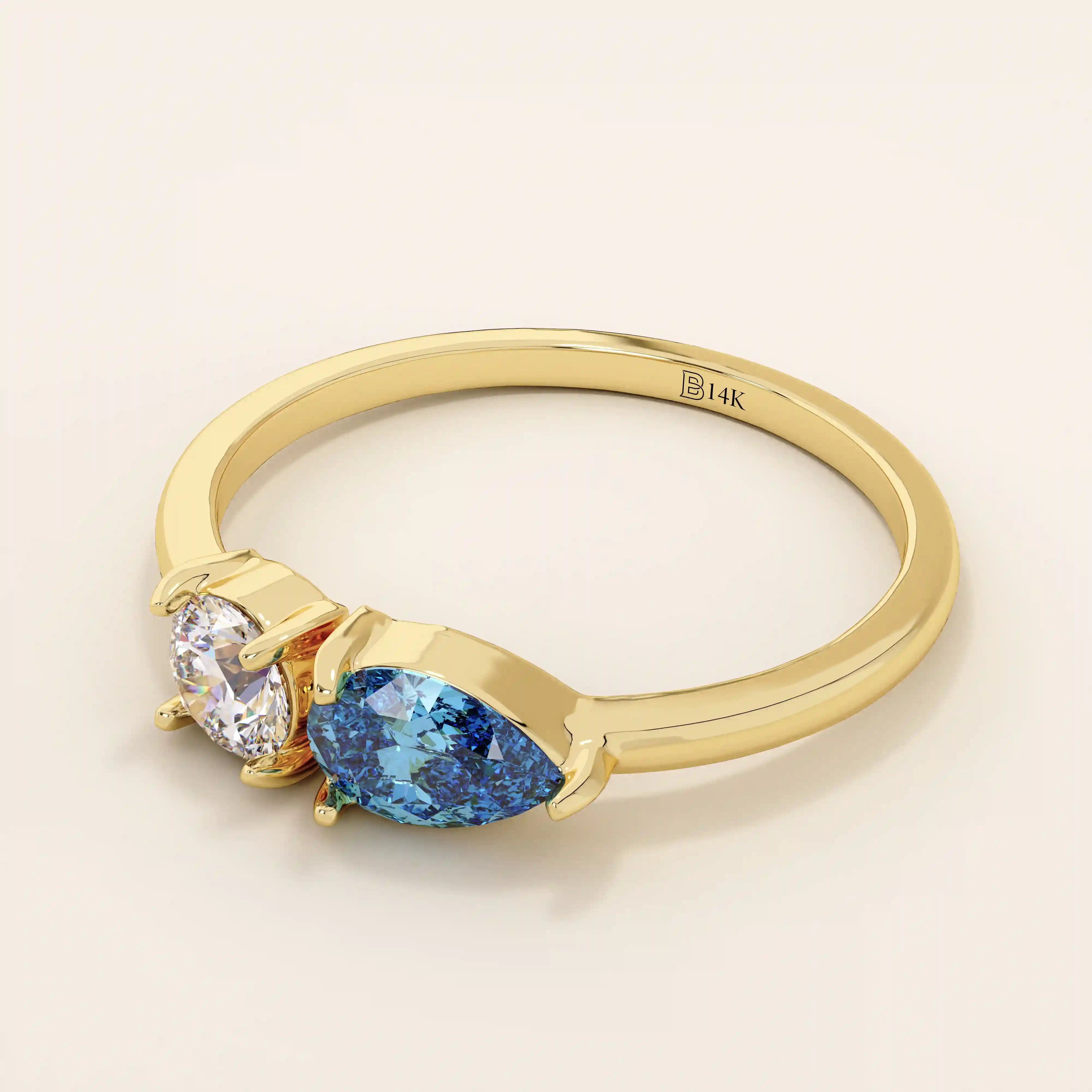 14k gold Toi et Moi ring with pear-shaped sapphire and round moissanite side by side. A symbolic two-stone engagement ring.