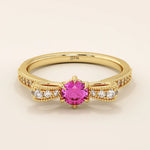 14k gold ribbon-shaped ring with a vibrant lab-grown ruby at the center. Elegant and romantic design with gemstone sparkle.