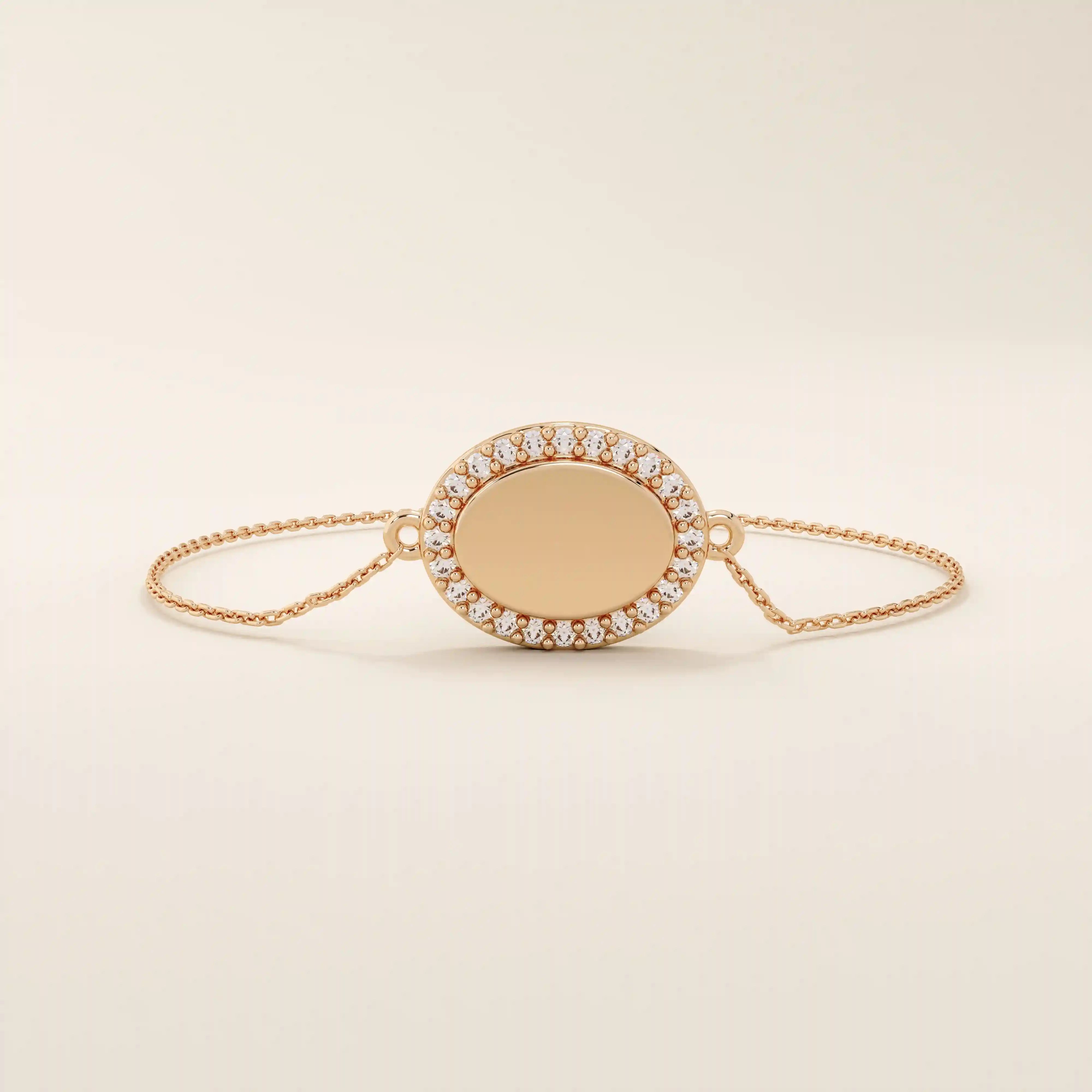 14k rose gold bracelet showcasing an oval charm encircled by pavé moissanite stones on a slim chain.