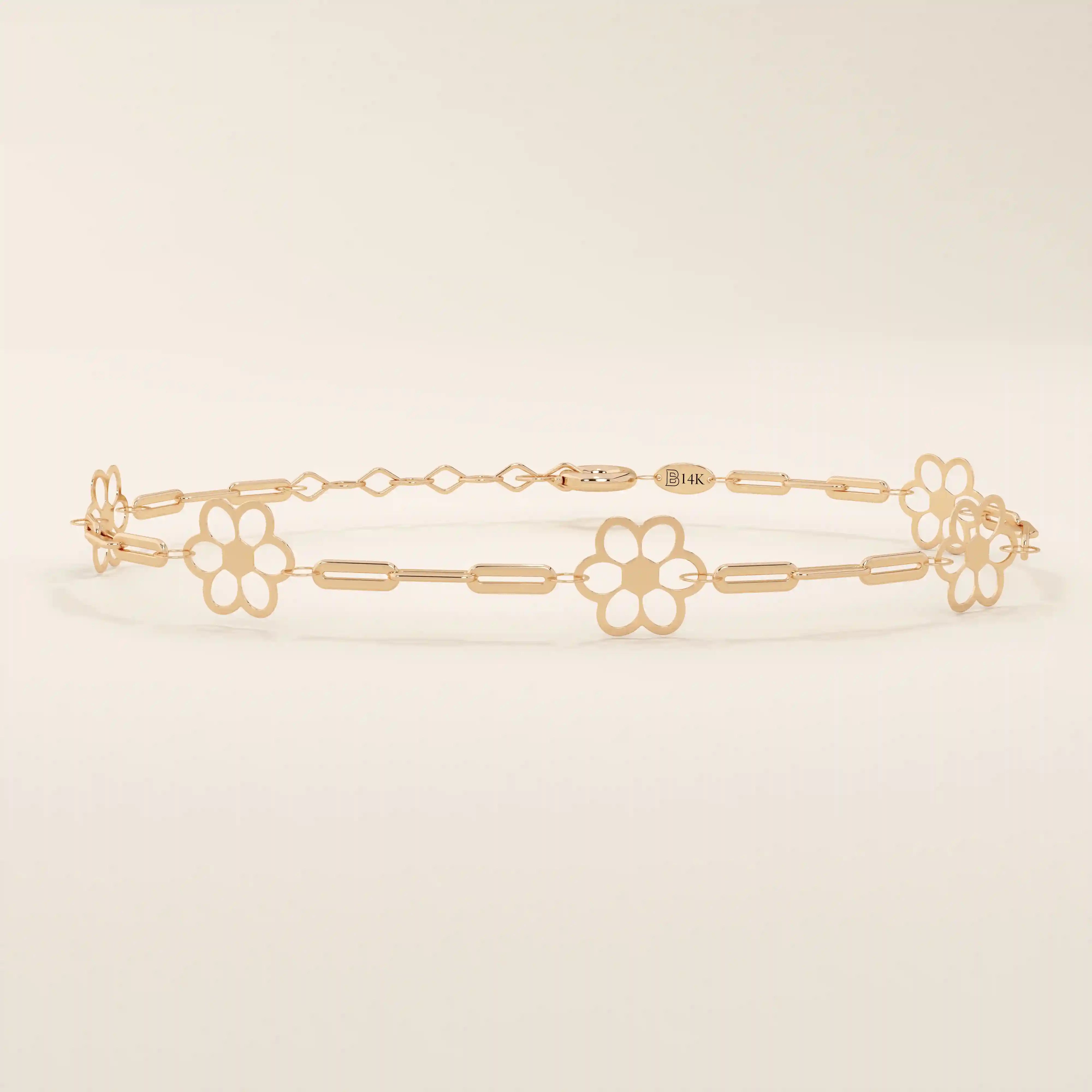 14k rose gold bracelet showcasing floral charms along a fine linked chain, adding a feminine touch.