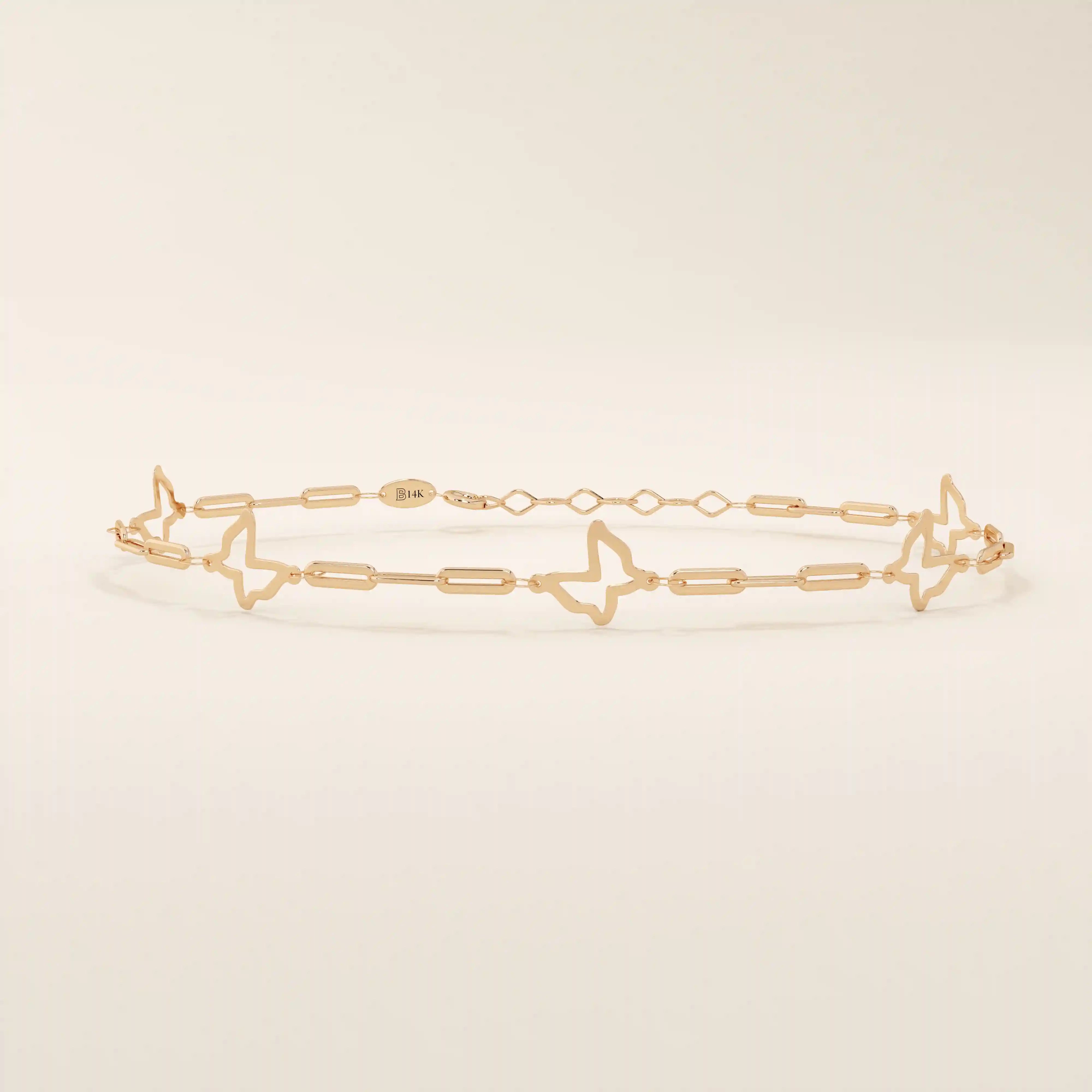 14k rose gold bracelet with airy butterfly cutout charms and slim chain details for a feminine design.