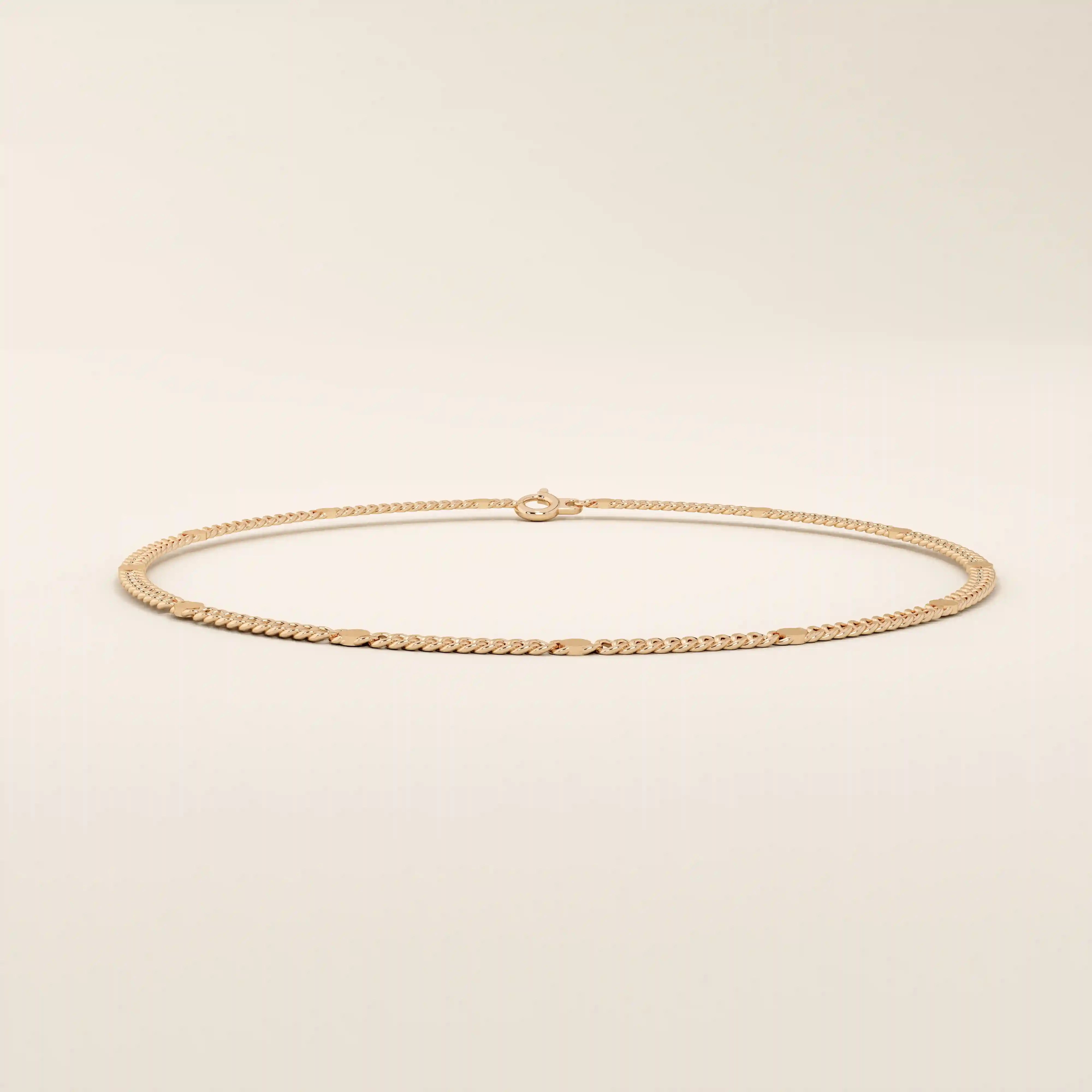 14k rose gold bracelet with curb-style chain links highlighted by round disc details.