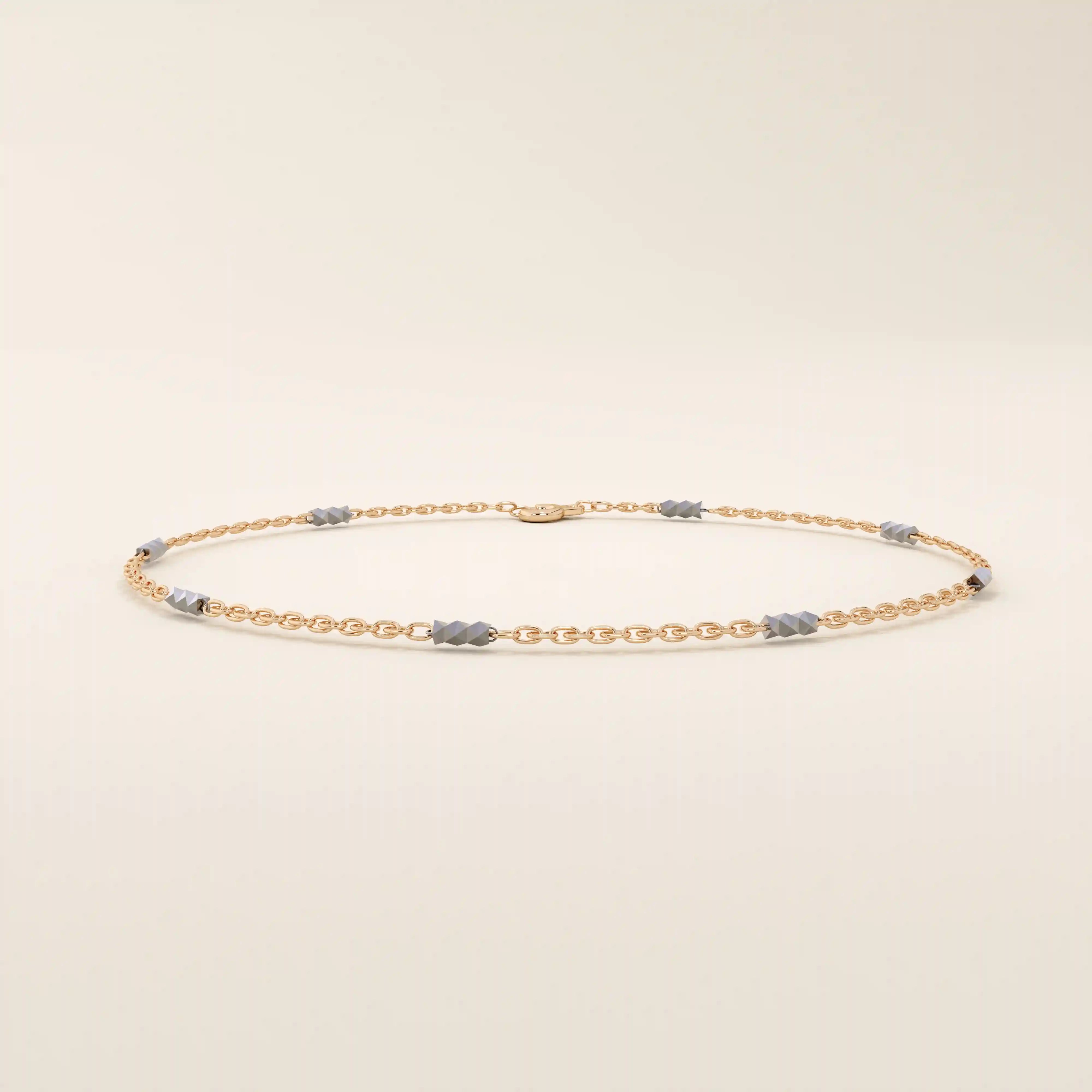 14k rose gold bracelet with oval chain links and contrasting white gold faceted bar details.