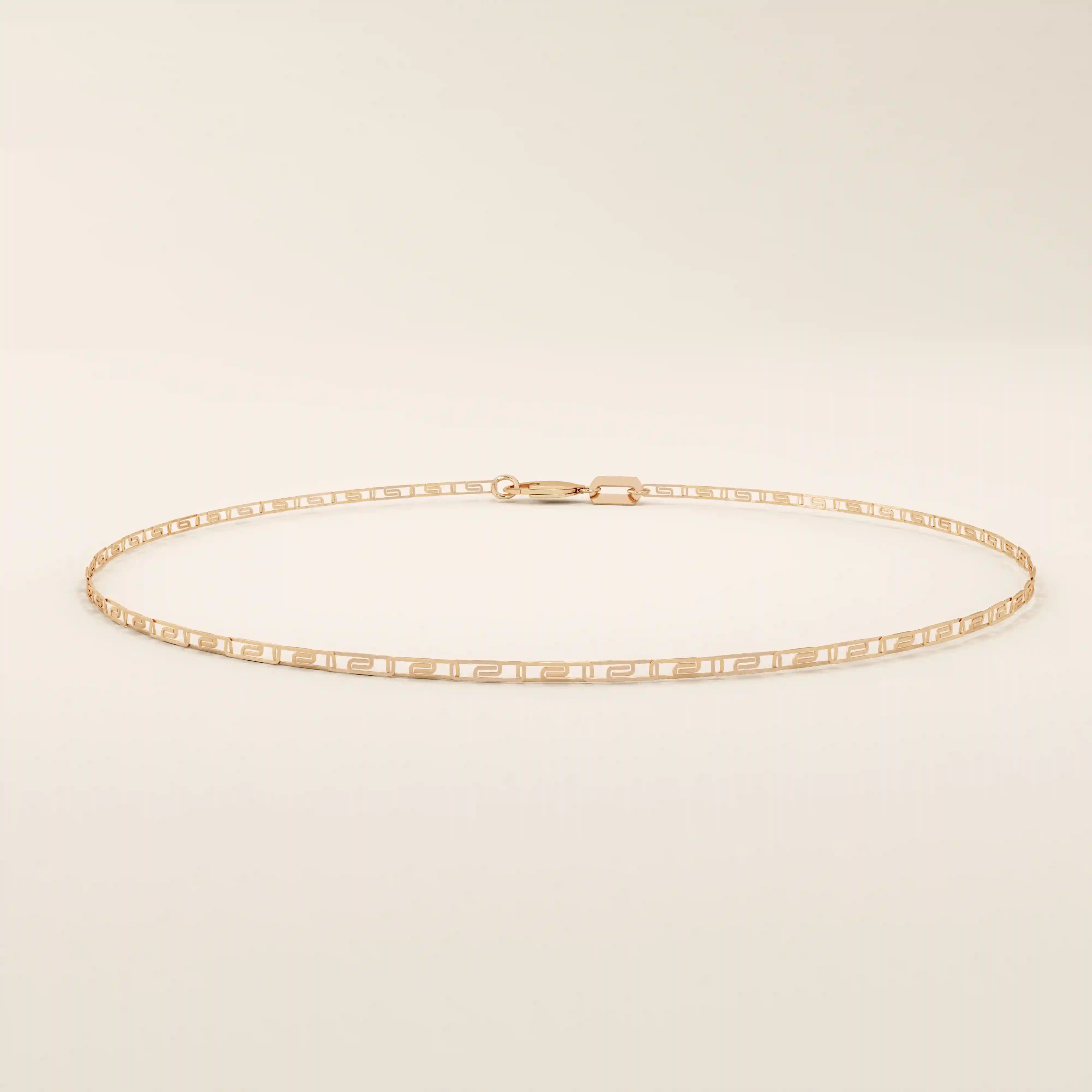 14k rose gold scroll chain bracelet designed with rectangular scrollwork links in a repeating elegant pattern.