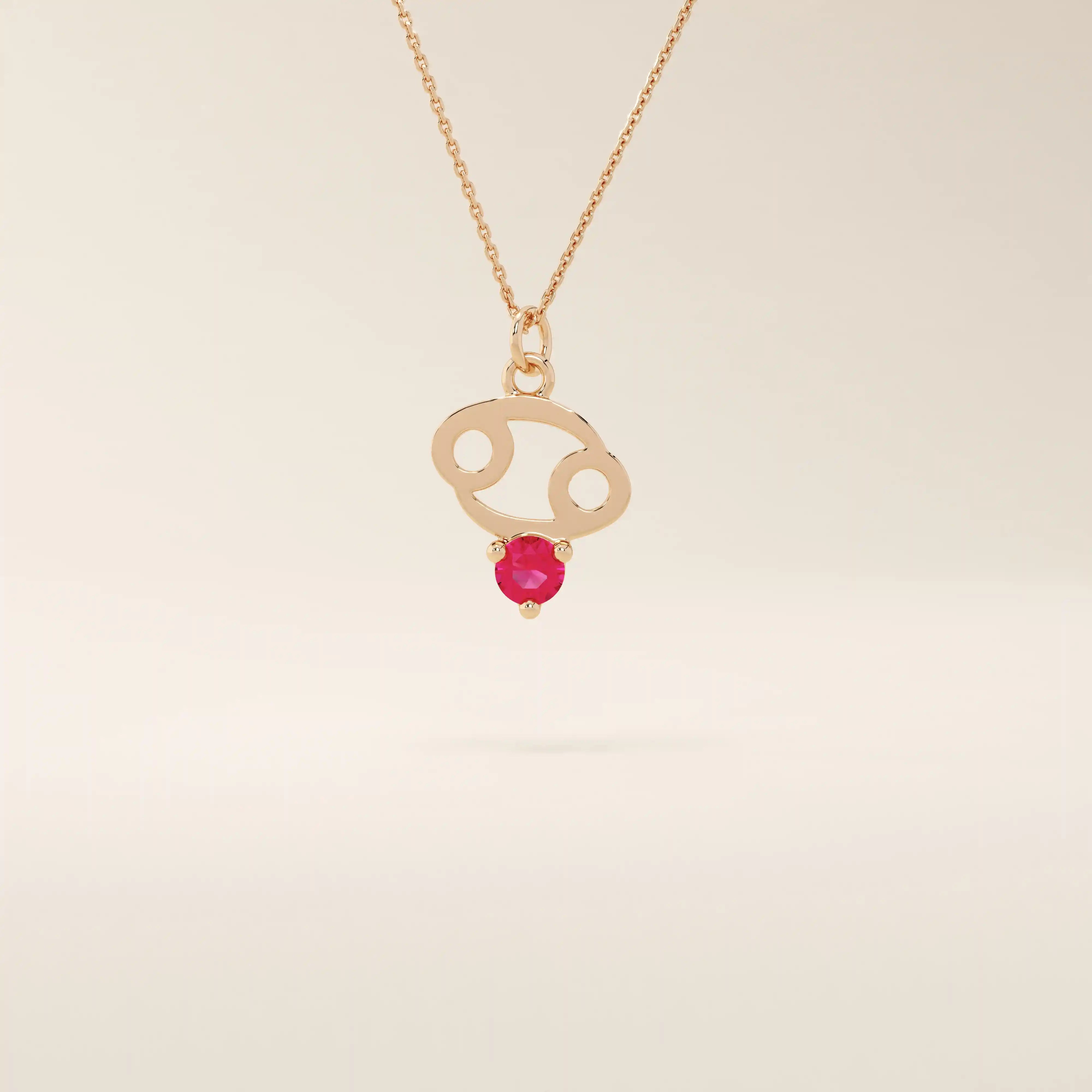 14k solid gold Cancer zodiac pendant necklace featuring a vibrant lab-grown ruby birthstone. A personalized and meaningful zodiac jewelry piece.
