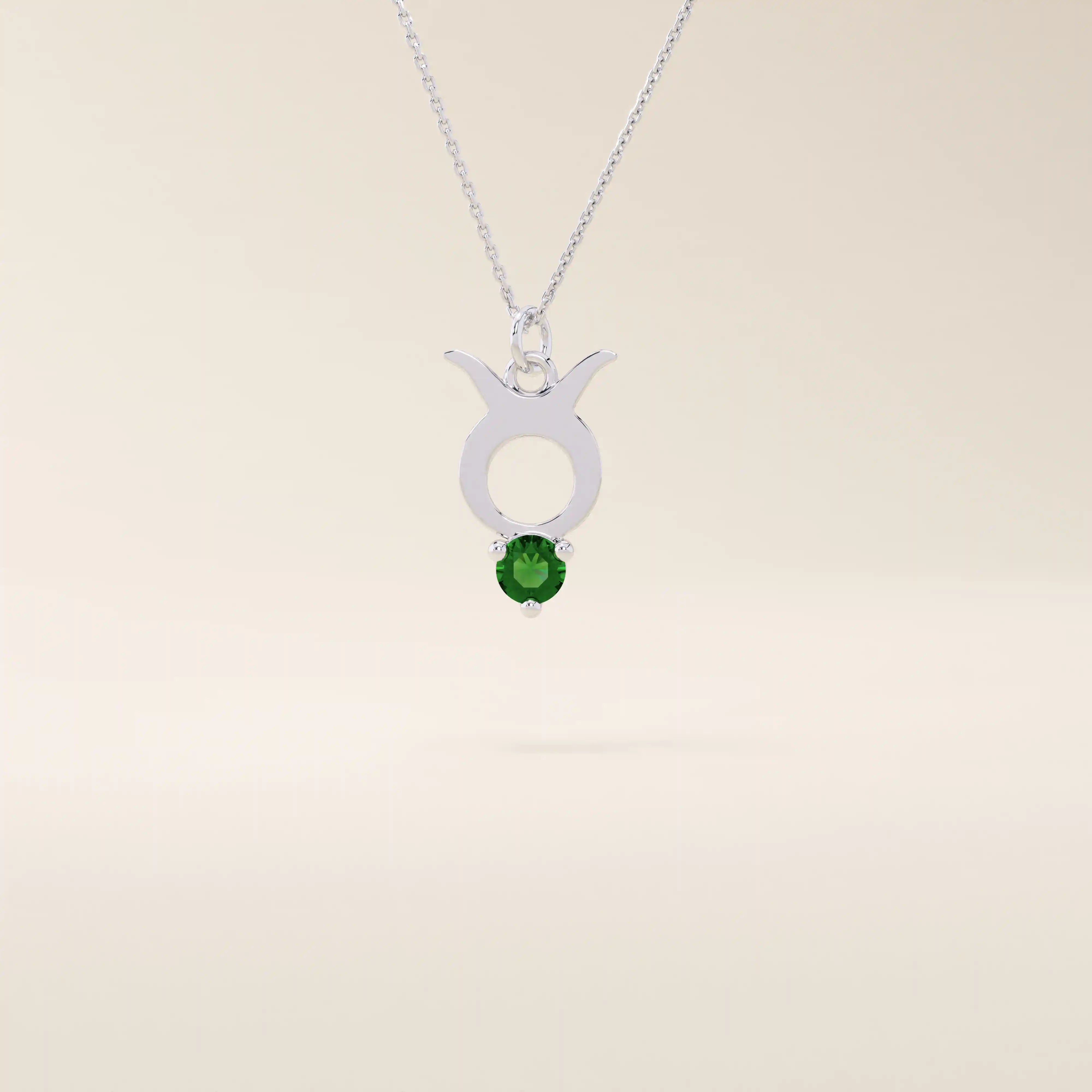 14k solid gold Taurus zodiac pendant necklace with a rich green emerald birthstone. A personalized and elegant zodiac accessory.