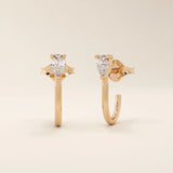 14k solid gold U-shaped stud earrings featuring a front-facing pear-cut moissanite. A unique and modern earring design. Perfect for daily wear or special occasions.