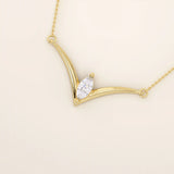 14k solid gold V-shape necklace with a marquise-cut moissanite at the center. Unique and modern gold necklace design. Dainty and minimalist jewelry for everyday wear.