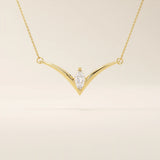 14k solid gold V-shape necklace with a marquise-cut moissanite at the center. Unique and modern gold necklace design. Dainty and minimalist jewelry for everyday wear.