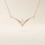 14k solid gold V-shape necklace with a marquise-cut moissanite at the center. Unique and modern gold necklace design. Dainty and minimalist jewelry for everyday wear.
