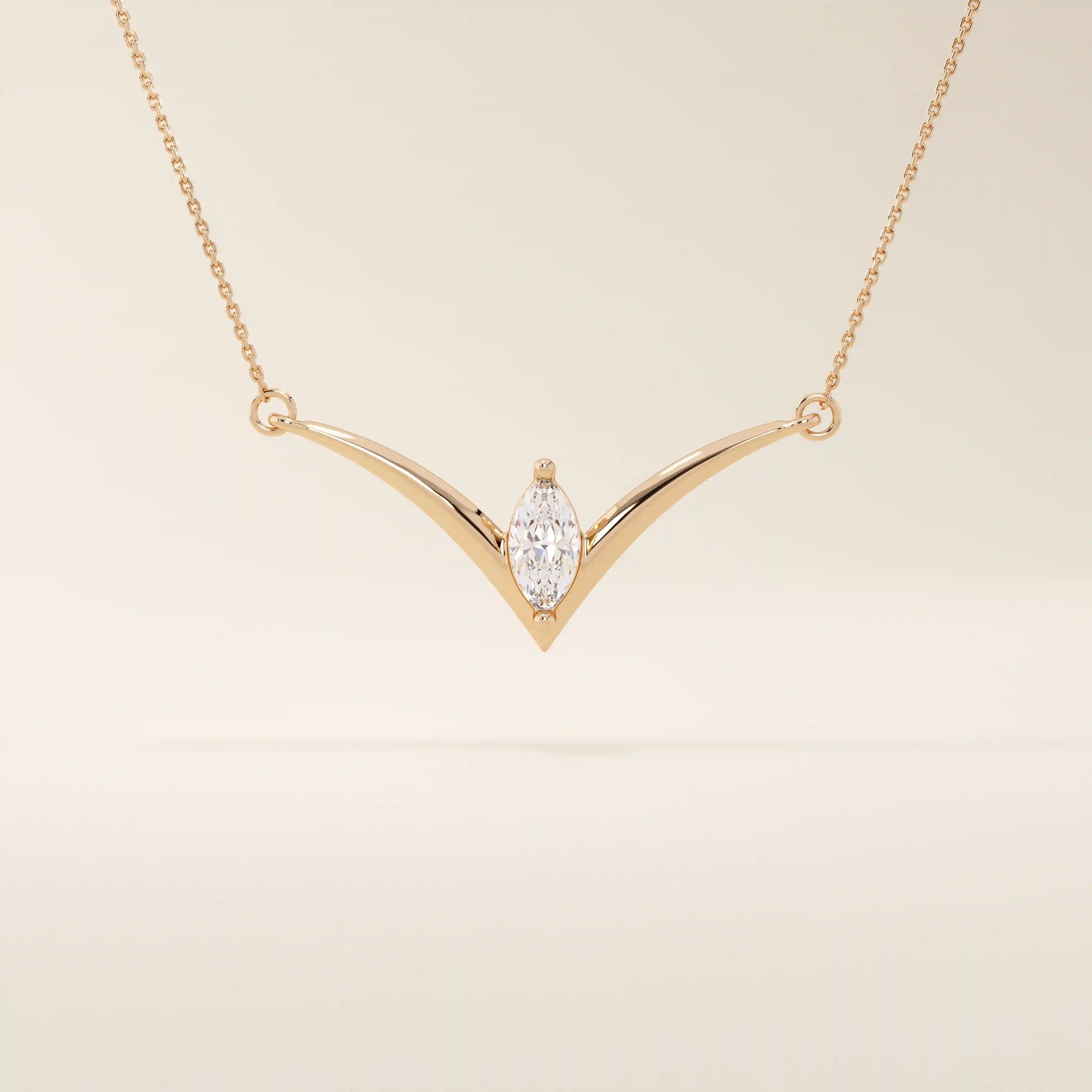 14k solid gold V-shape necklace with a marquise-cut moissanite at the center. Unique and modern gold necklace design. Dainty and minimalist jewelry for everyday wear.