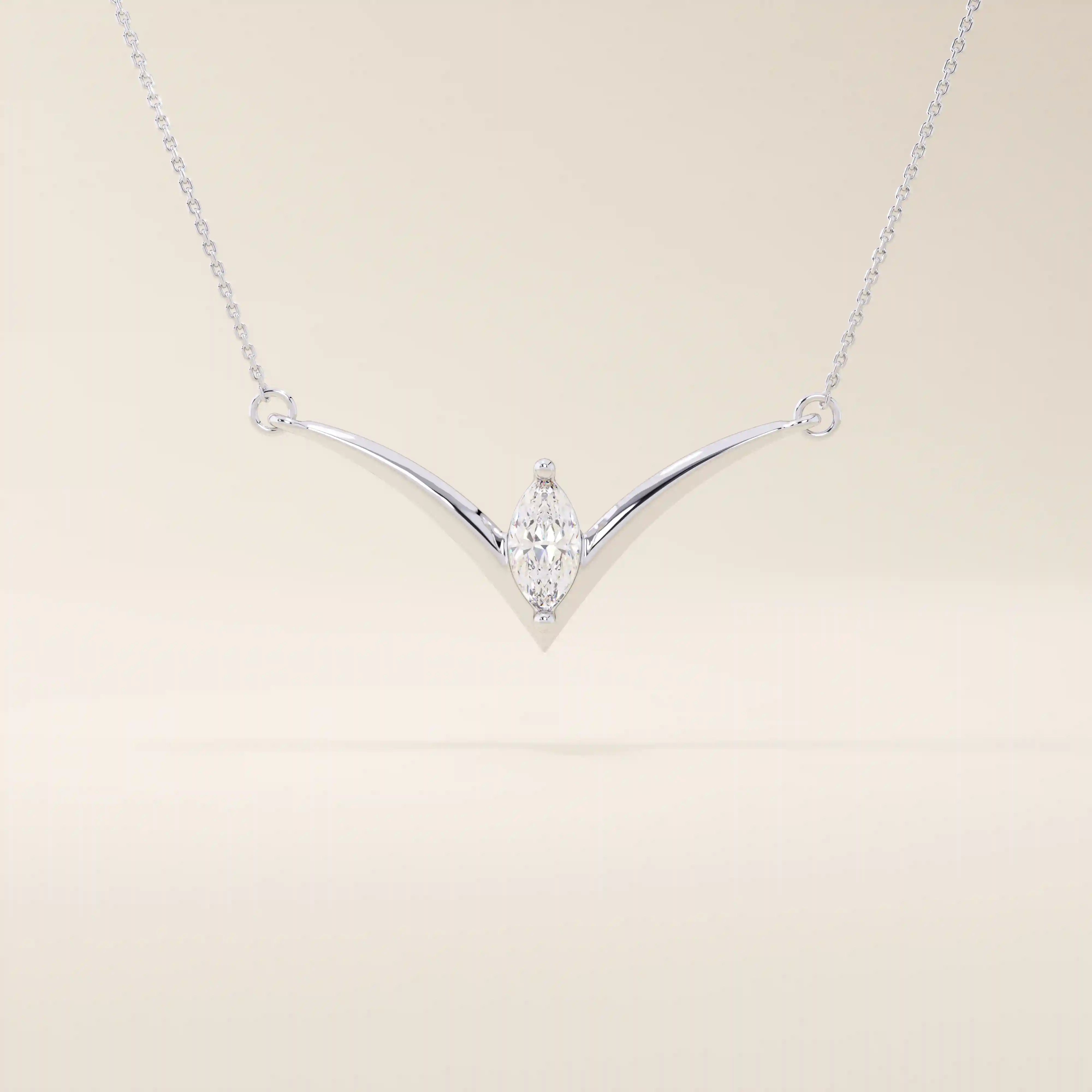 14k solid gold V-shape necklace with a marquise-cut moissanite at the center. Unique and modern gold necklace design. Dainty and minimalist jewelry for everyday wear.