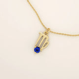 14k solid gold Virgo zodiac symbol pendant necklace with a round blue sapphire, minimalist astrology birthstone jewelry.