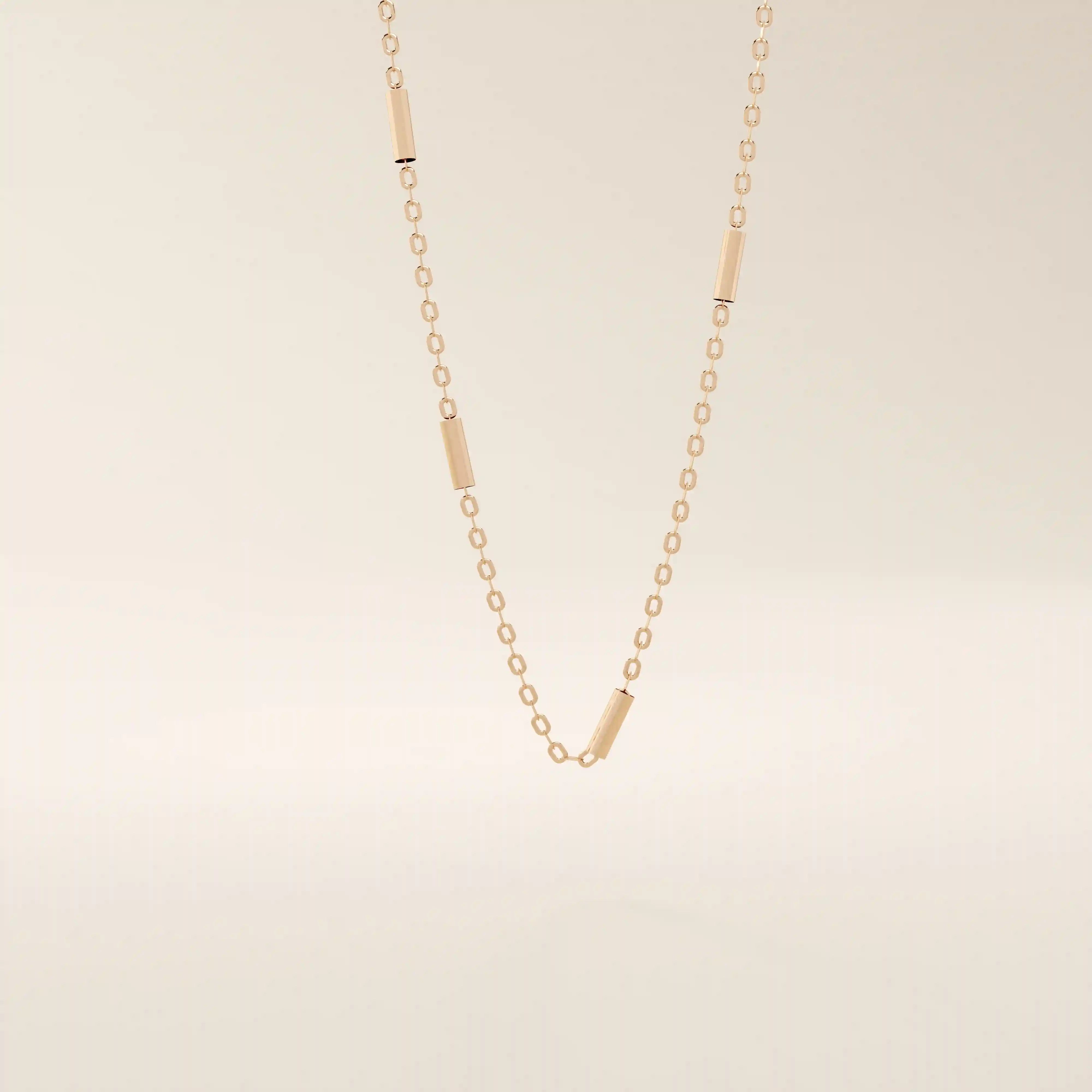 14k solid gold bar chain necklace with sleek horizontal links and a polished finish. A modern and minimal gold chain. Great for layering or wearing alone.