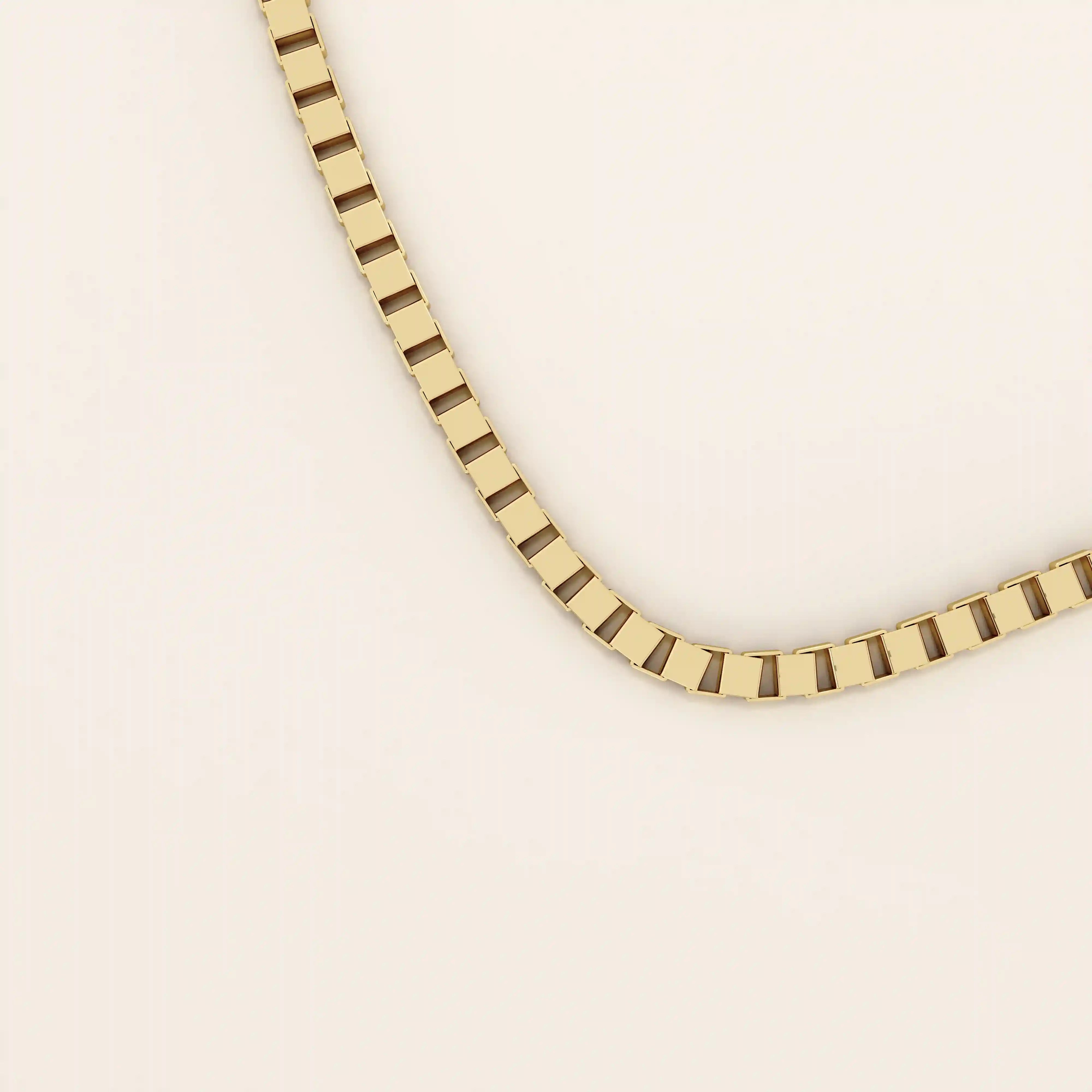 14k solid gold box chain necklace with square-shaped links and a smooth finish. A timeless and durable gold chain. Ideal for daily wear or layering.
