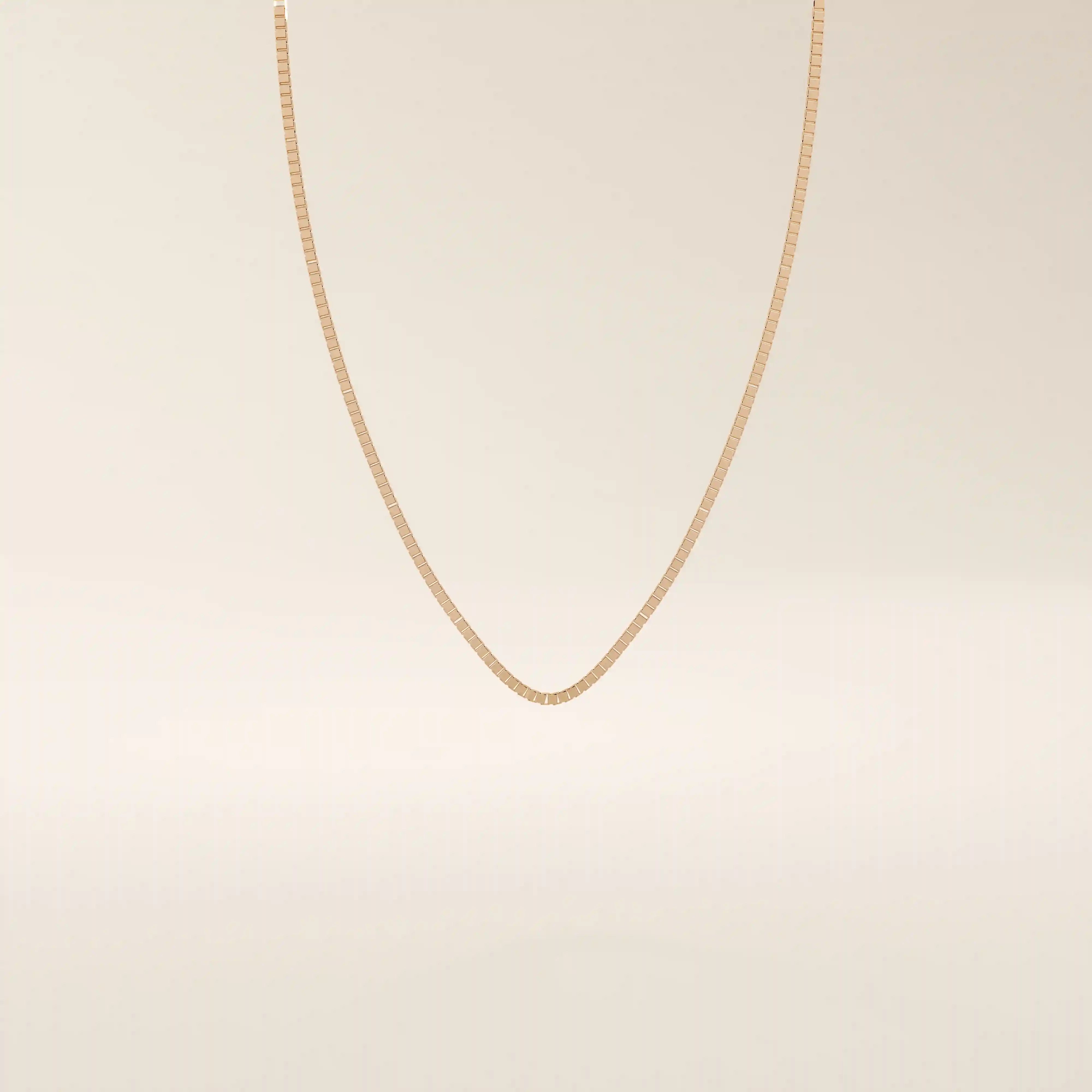 14k solid gold box chain necklace with square-shaped links and a smooth finish. A timeless and durable gold chain. Ideal for daily wear or layering.