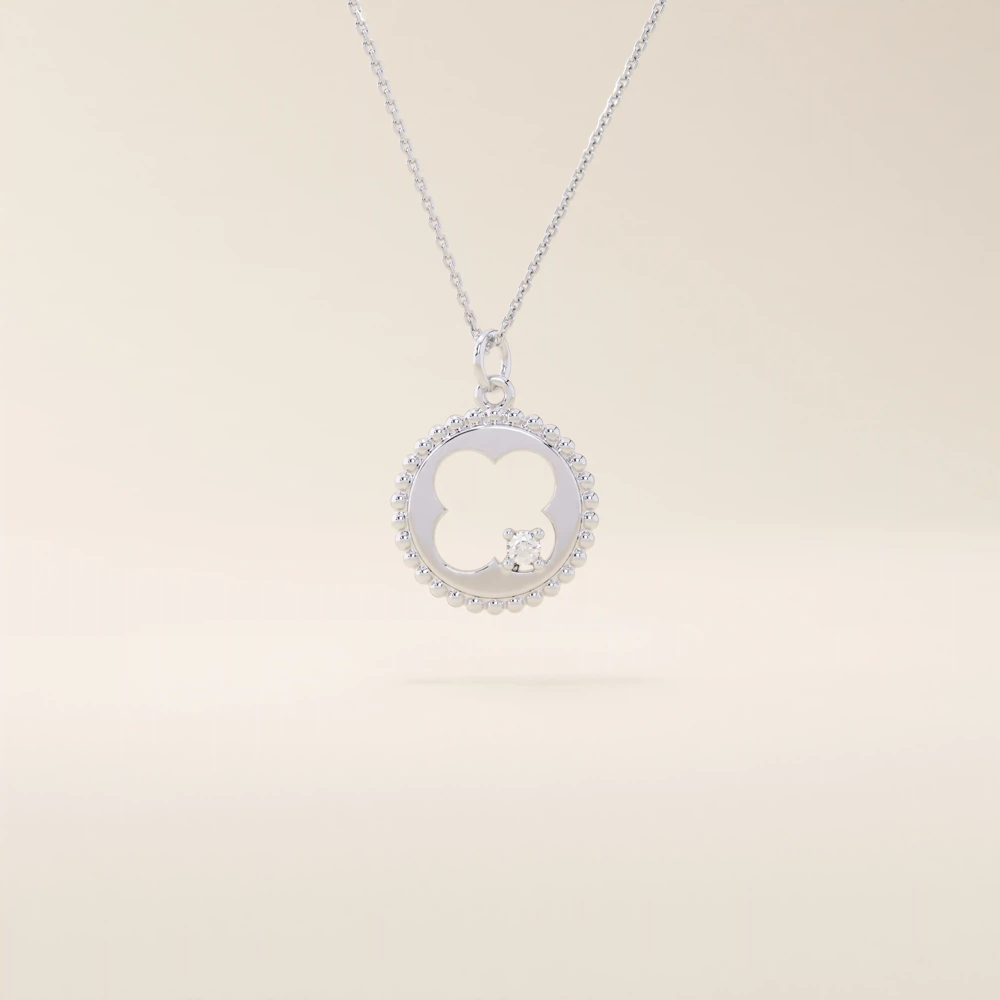 14k solid gold circle pendant necklace featuring a clover-shaped cutout and a single sparkling moissanite. Symbolic and delicate design.