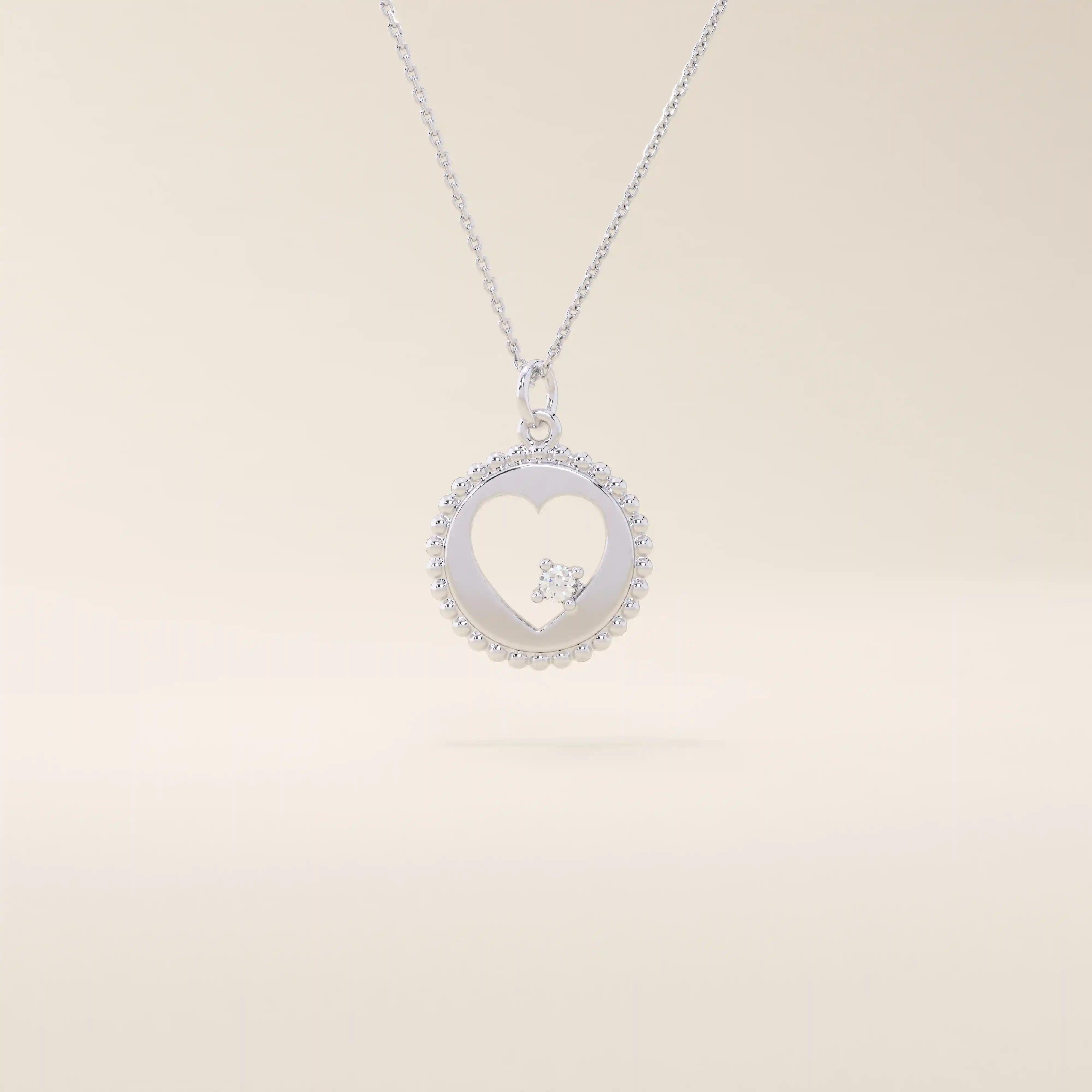 14k solid gold circle pendant necklace featuring a heart-shaped cutout and a single sparkling moissanite. Delicate and meaningful design.