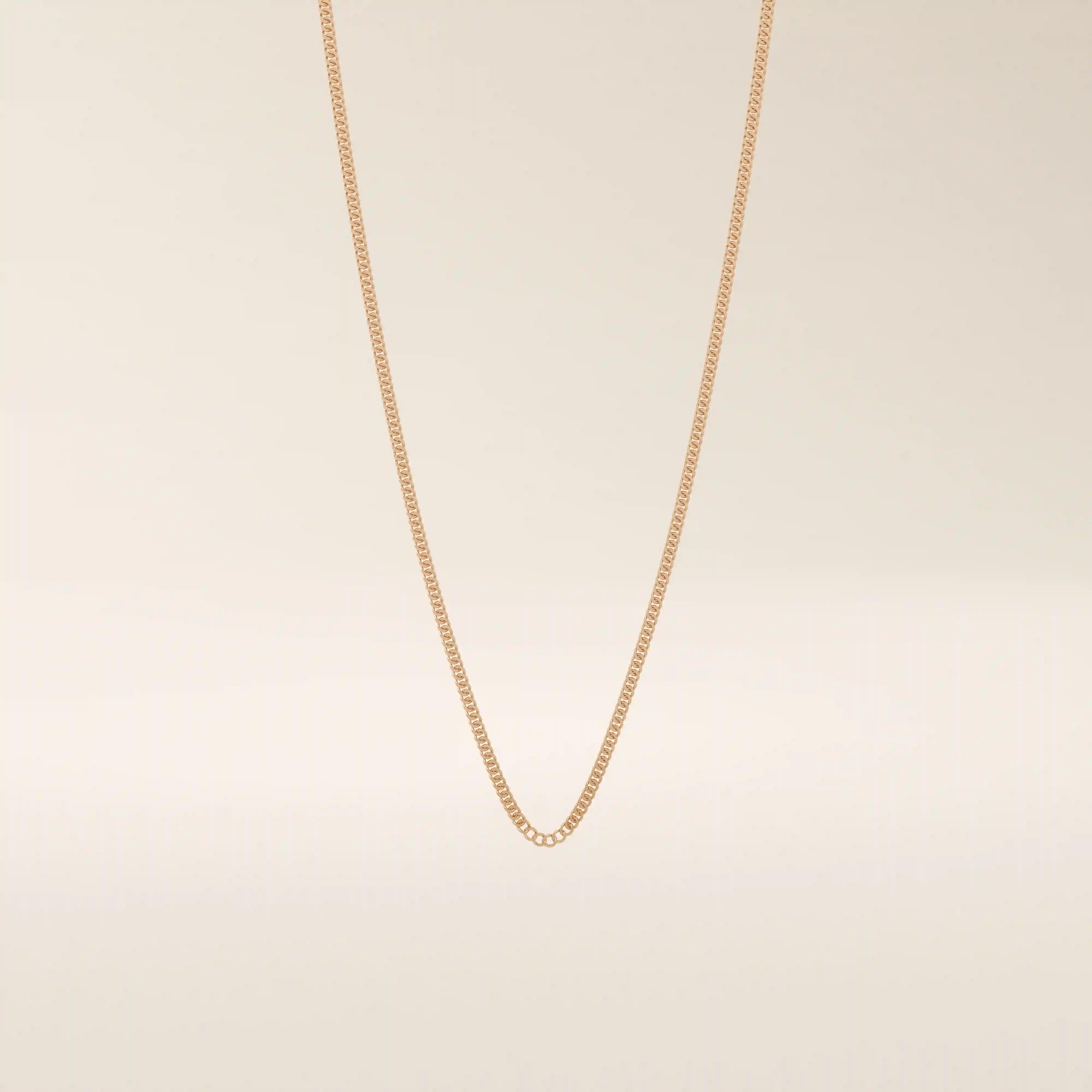14k solid gold curb chain necklace with flat, closely interlocked links and a polished finish. A timeless and sturdy gold chain. Ideal for everyday wear or layering.