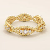 14k solid gold eternity statement ring with a unique twisted band design, adorned with sparkling moissanites. Elegant and modern.