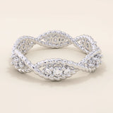 14k solid gold eternity statement ring with a unique twisted band design, adorned with sparkling moissanites. Elegant and modern.