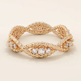 14k solid gold eternity statement ring with a unique twisted band design, adorned with sparkling moissanites. Elegant and modern.