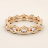 14k solid gold geometric eternity band ring featuring rhombus shapes adorned with sparkling moissanites. Bold and modern design.