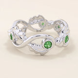 14k solid gold leaf vine band ring with a bezel-set emerald gemstone. Nature-inspired statement design.