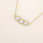14k solid gold necklace featuring three bezel-set moissanite stones. A minimalist and stackable design perfect for layering everyday jewelry.