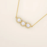 14k solid gold necklace featuring three bezel-set moissanite stones. A minimalist and stackable design perfect for layering everyday jewelry.