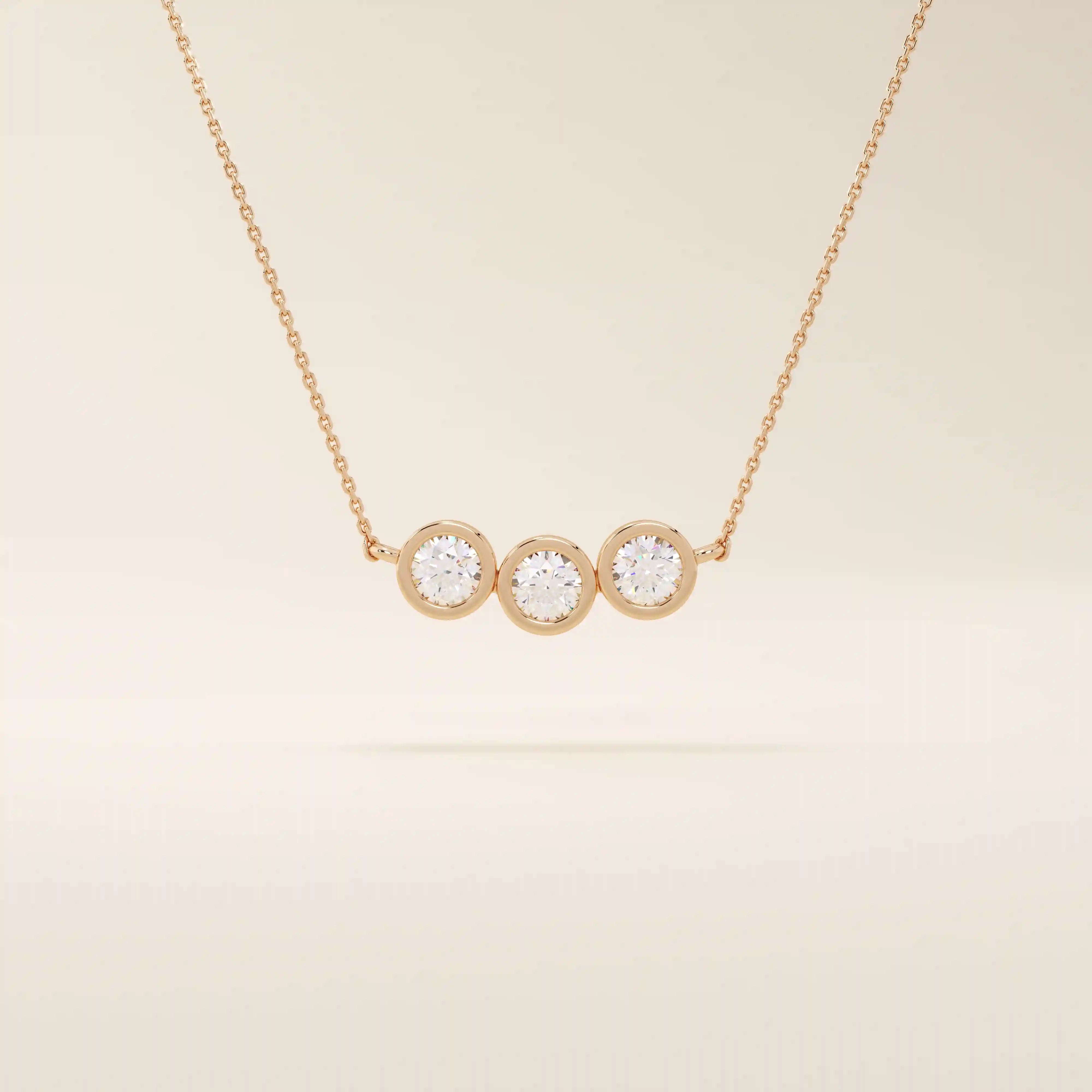 14k solid gold necklace featuring three bezel-set moissanite stones. A minimalist and stackable design perfect for layering everyday jewelry.