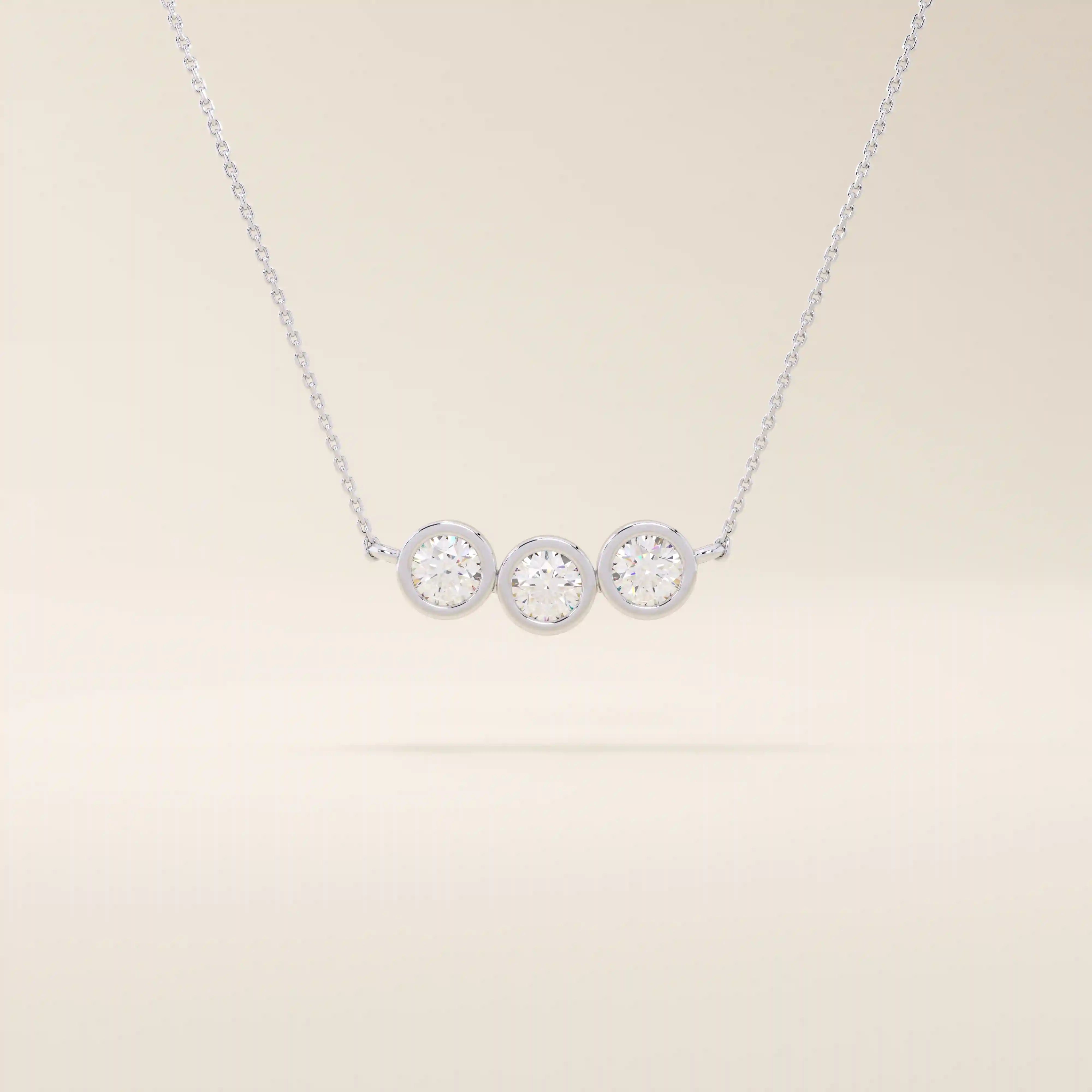 14k solid gold necklace featuring three bezel-set moissanite stones. A minimalist and stackable design perfect for layering everyday jewelry.