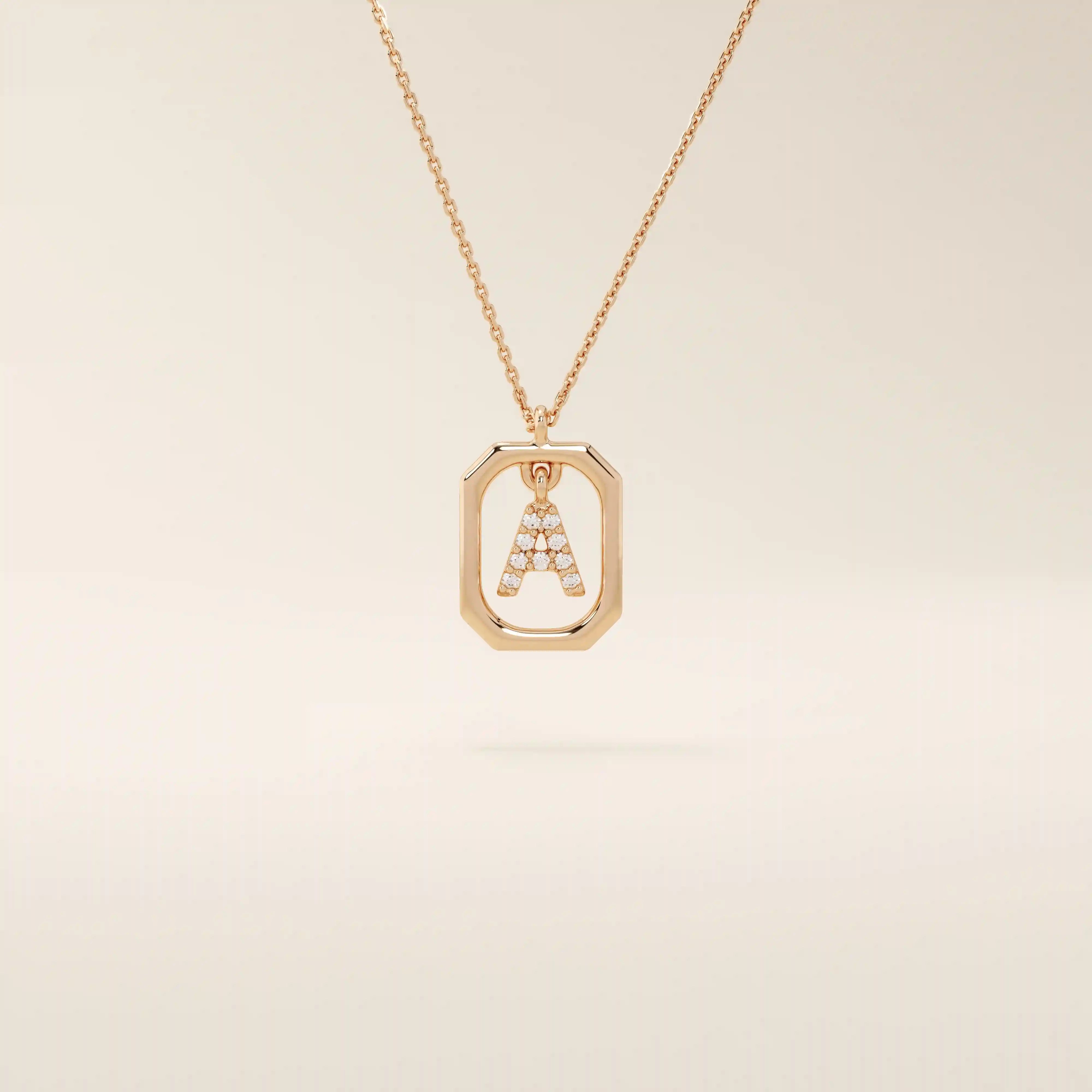 14k solid gold rectangle-shaped necklace featuring a personalized dangling initial letter. A modern and customizable everyday accessory.