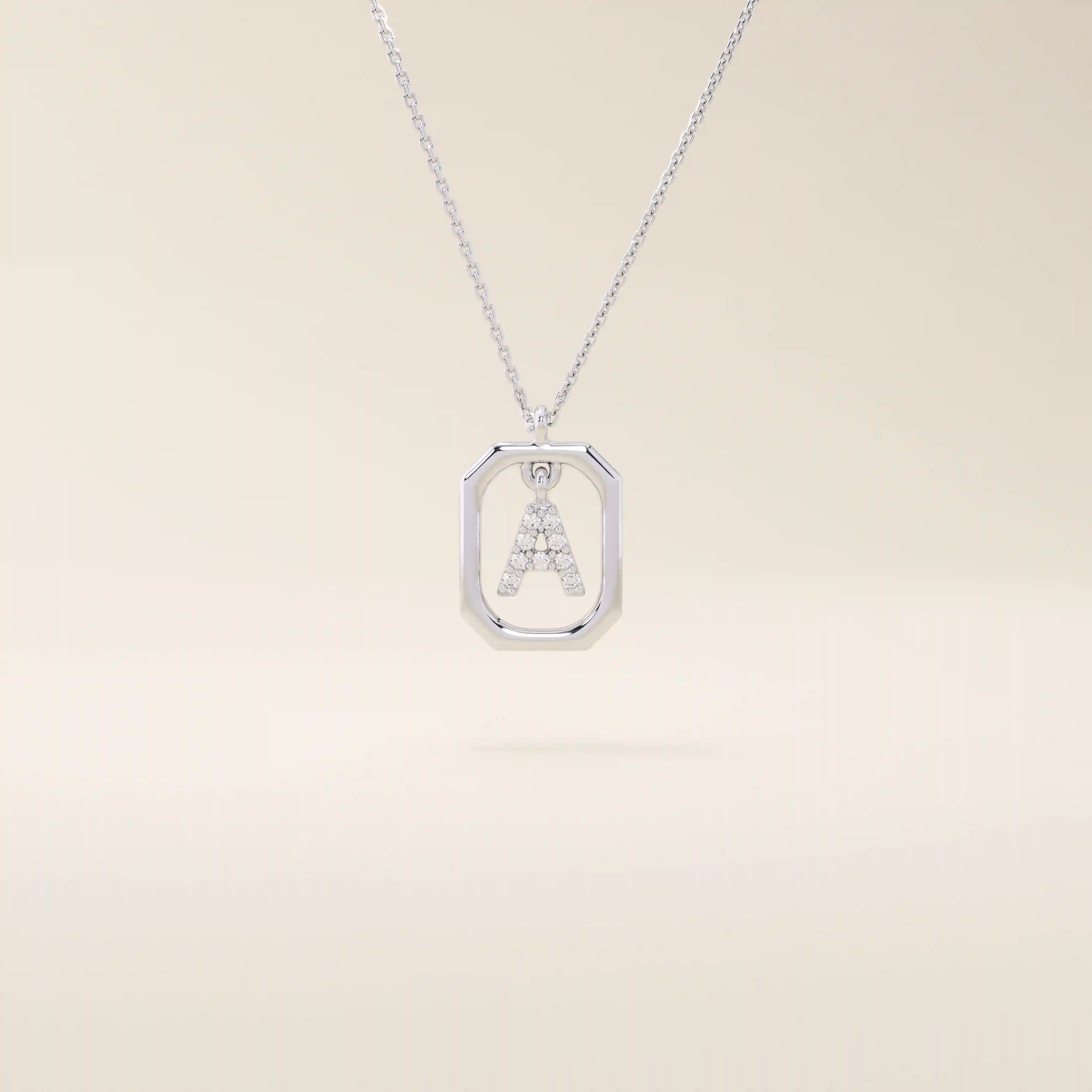 14k solid gold rectangle-shaped necklace featuring a personalized dangling initial letter. A modern and customizable everyday accessory.