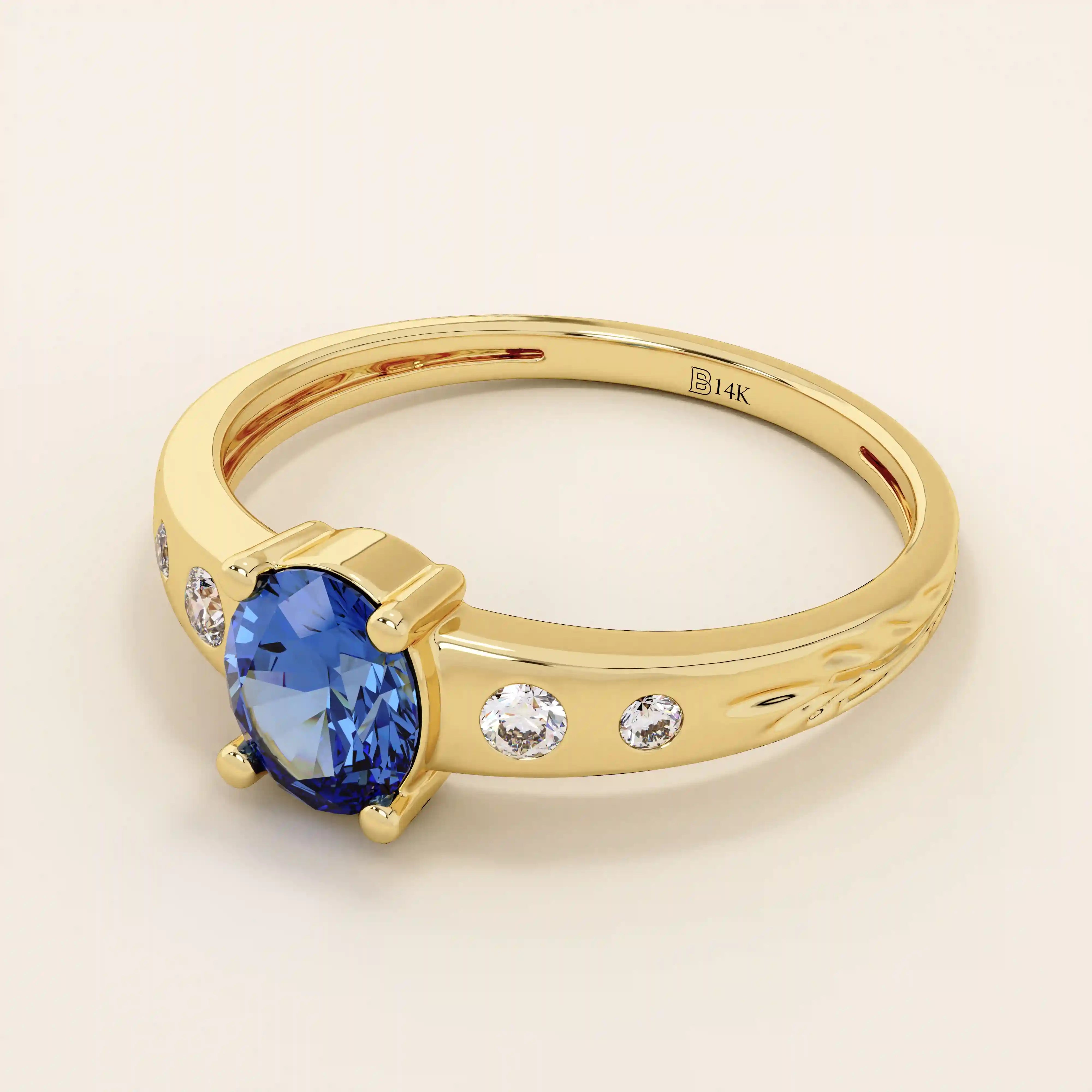 14k solid gold ring featuring an oval cut sapphire gemstone. Timeless and rich in color, perfect for everyday wear or special occasions.