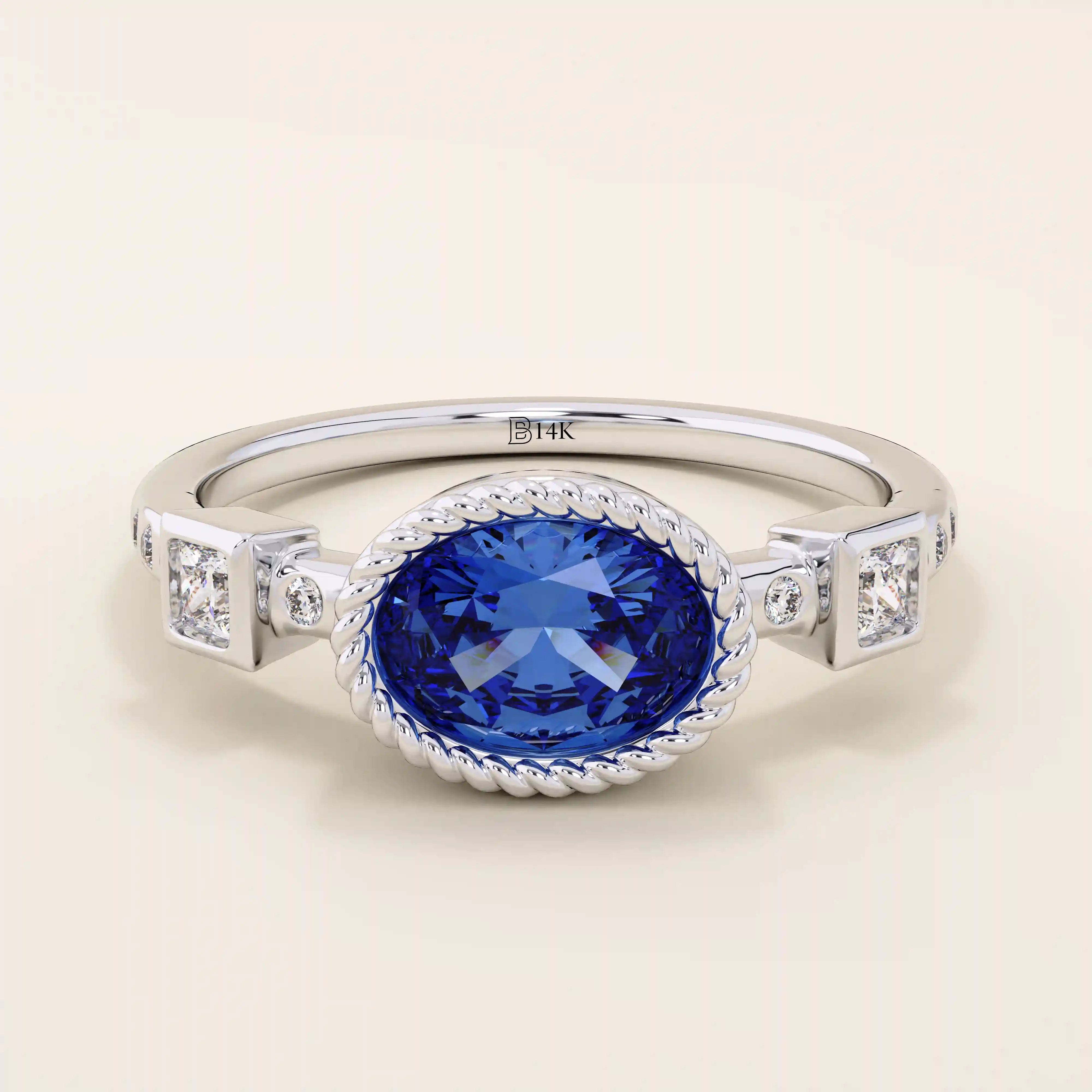 14k solid gold ring with bezel set oval sapphire and accent moissanites. A vintage-inspired solitaire gemstone ring with timeless charm.