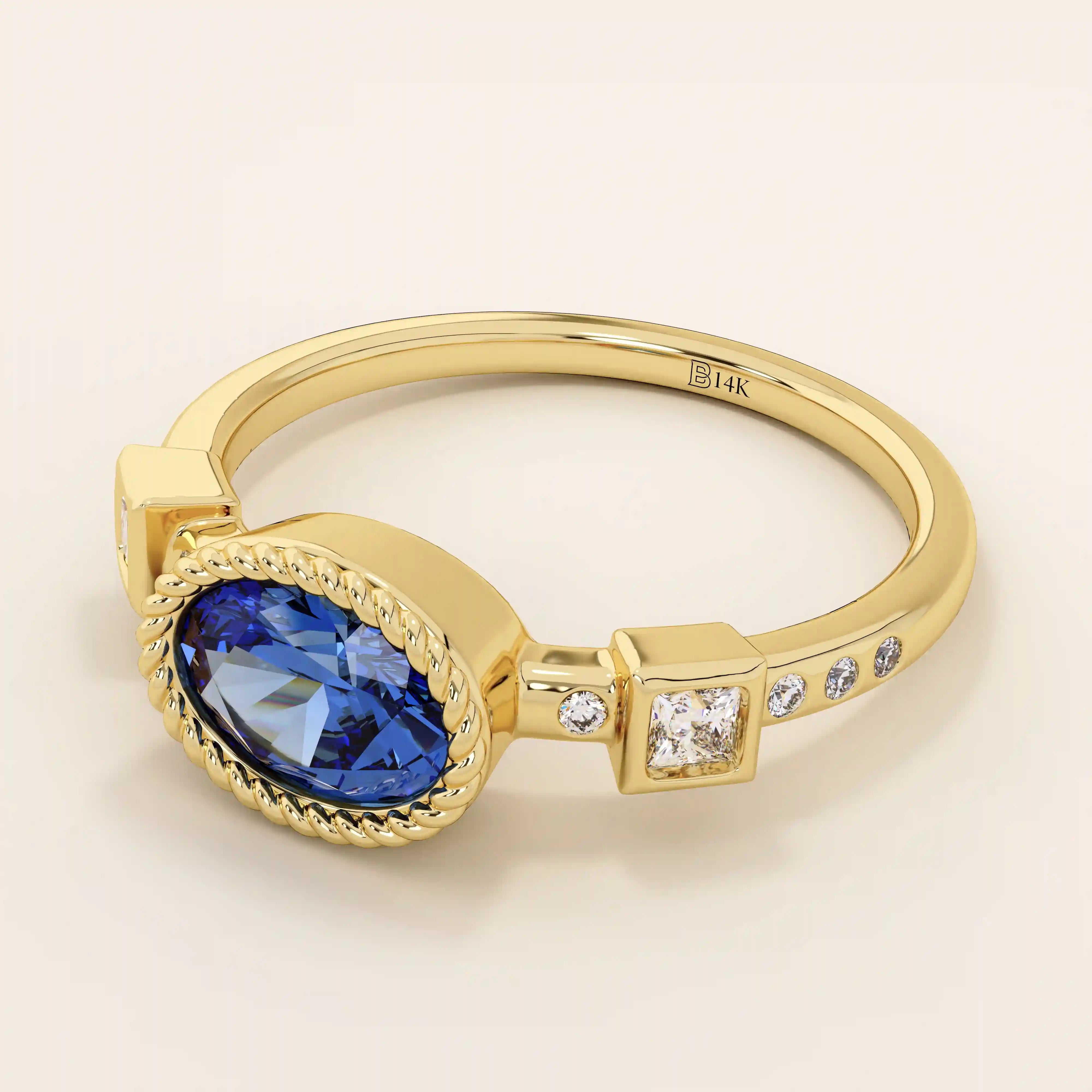 14k solid gold ring with bezel set oval sapphire and accent moissanites. A vintage-inspired solitaire gemstone ring with timeless charm.