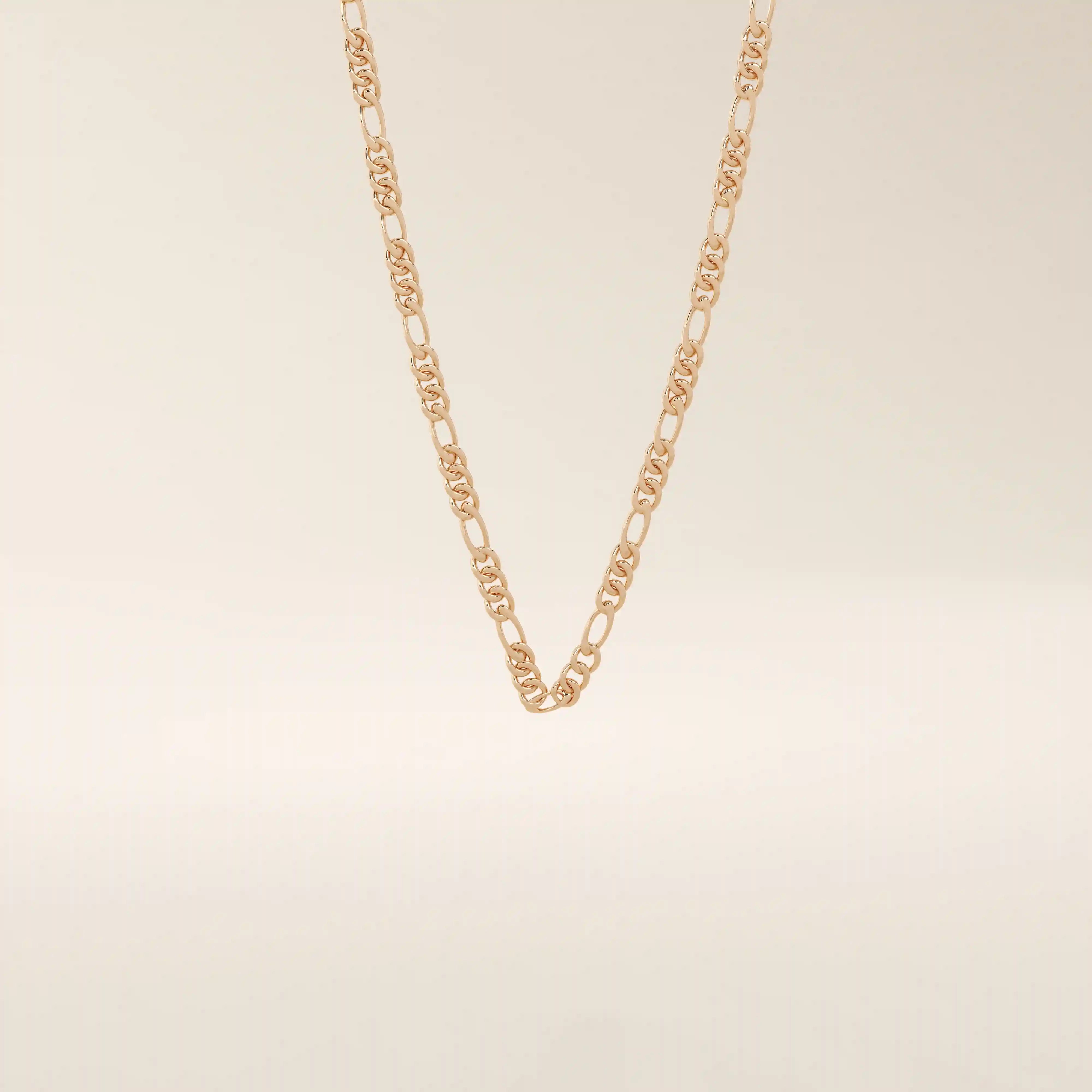 14k solid gold slim Figaro chain necklace with alternating short and long links. A classic and lightweight gold chain. Perfect for layering or daily wear.