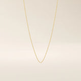 14k solid gold slim link chain necklace with a lightweight and polished finish. A delicate and timeless gold chain. Ideal for layering or wearing solo.