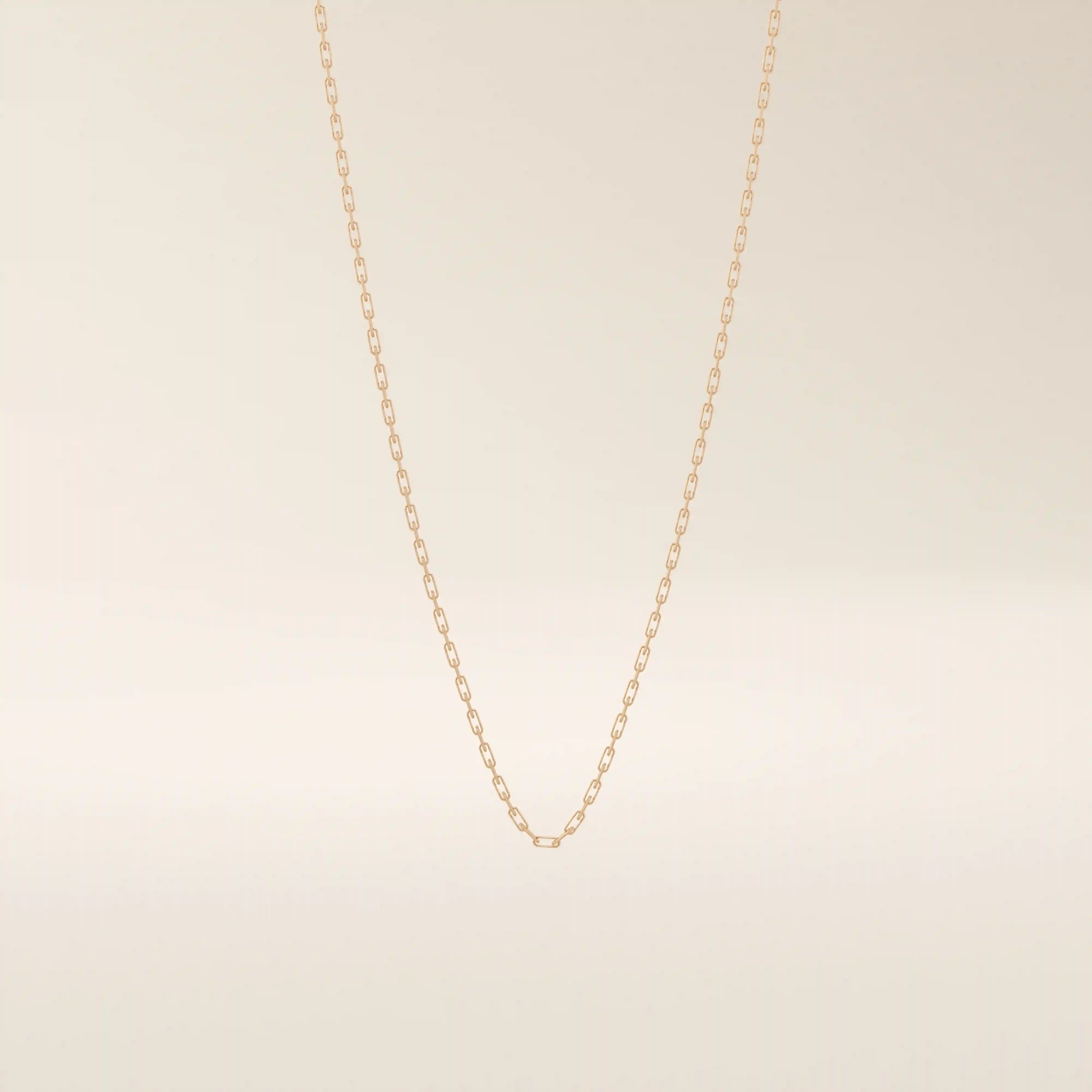14k solid gold slim link chain necklace with a lightweight and polished finish. A delicate and timeless gold chain. Ideal for layering or wearing solo.