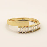14k solid gold spiral statement ring with baguette-cut half eternity moissanites. Modern and elegant wrap-around design.