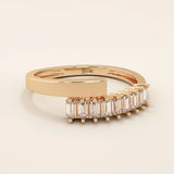 14k solid gold spiral statement ring with baguette-cut half eternity moissanites. Modern and elegant wrap-around design.