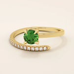 14k solid gold spiral wrap ring featuring a vivid green emerald gemstone. A bold yet elegant design with fluid curves. Perfect as a statement ring or unique gift.