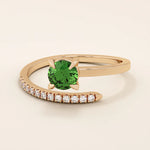 14k solid gold spiral wrap ring featuring a vivid green emerald gemstone. A bold yet elegant design with fluid curves. Perfect as a statement ring or unique gift.