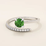 14k solid gold spiral wrap ring featuring a vivid green emerald gemstone. A bold yet elegant design with fluid curves. Perfect as a statement ring or unique gift.