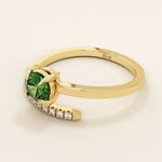 14k solid gold spiral wrap ring featuring a vivid green emerald gemstone. A bold yet elegant design with fluid curves. Perfect as a statement ring or unique gift.