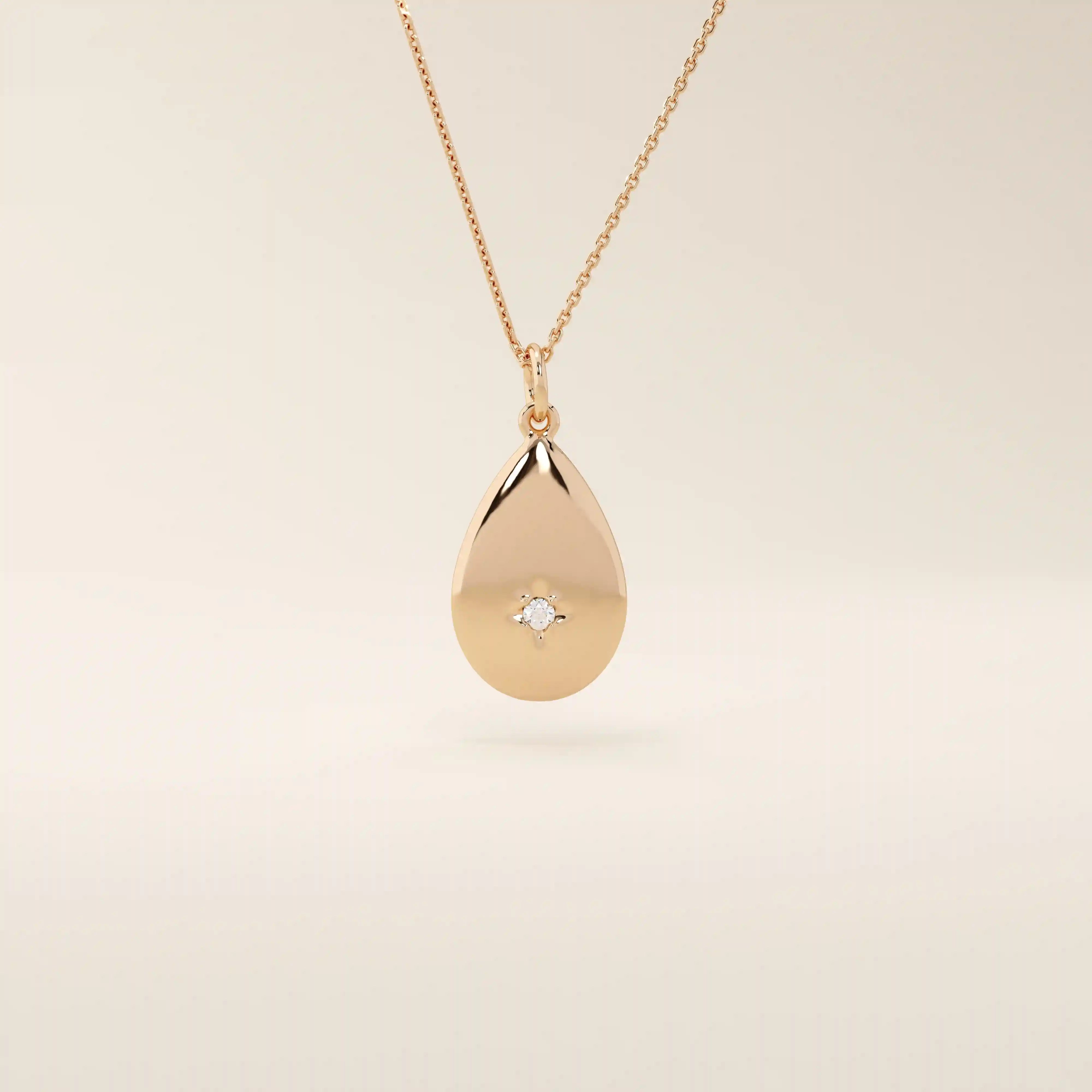 14k solid gold teardrop pendant necklace featuring a single tiny moissanite in the center. Minimalist and timeless jewelry design. Perfect for everyday wear.