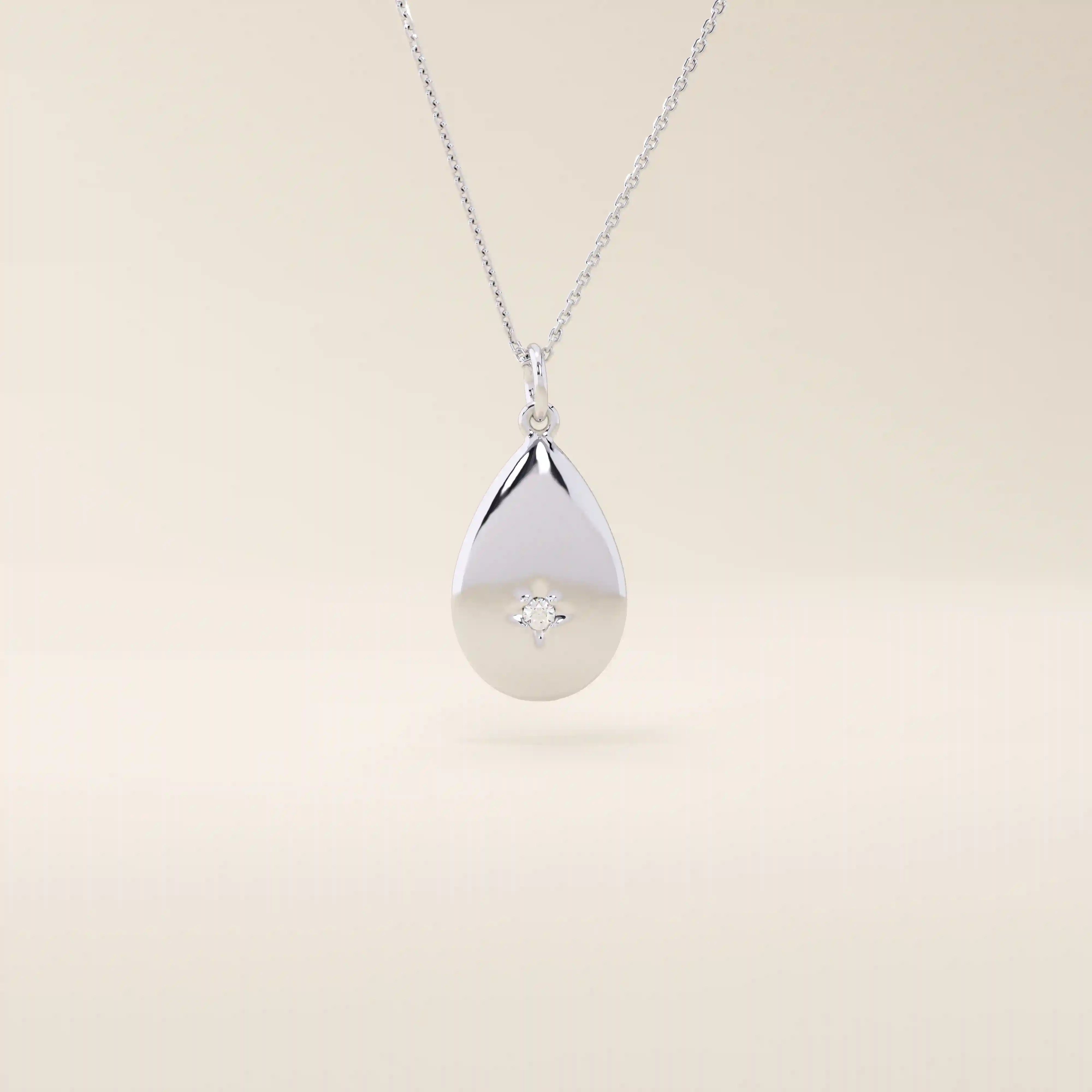 14k solid gold teardrop pendant necklace featuring a single tiny moissanite in the center. Minimalist and timeless jewelry design. Perfect for everyday wear.