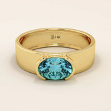 14k solid gold thick band ring with an oval cut topaz in a half bezel setting. Bold yet refined gemstone design. Perfect for stacking or solo wear.