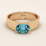 14k solid gold thick band ring with an oval cut topaz in a half bezel setting. Bold yet refined gemstone design. Perfect for stacking or solo wear.